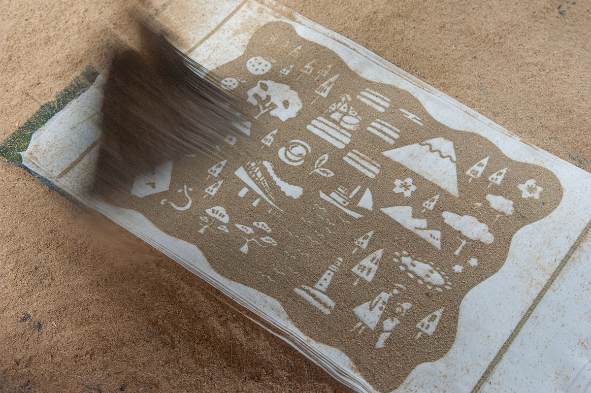 Brushing sawdust onto the tenugui print